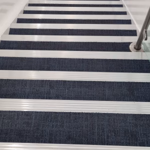 Castellated nosings and carpet tiles to staircase scaled Castellated nosings and carpet tiles to staircase scaled